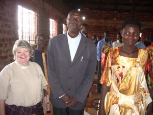 standing with my former student, Rev. David Mwebya